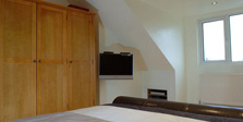 Loft conversion bed, TV and windows